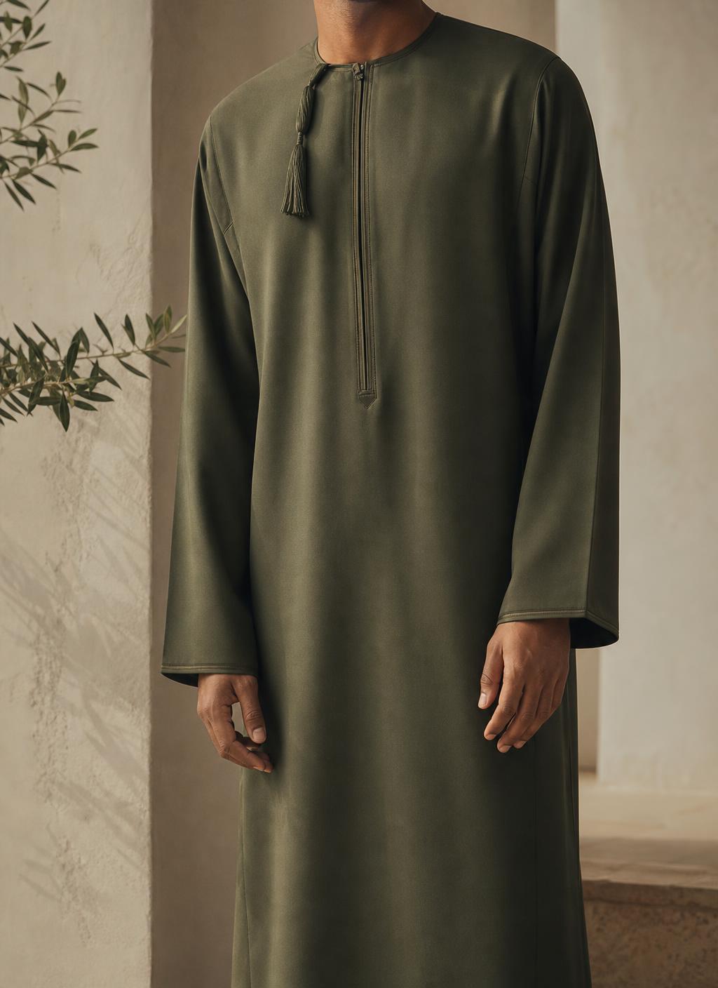 Man wearing a premium olive green Omani thobe with furakha tassel